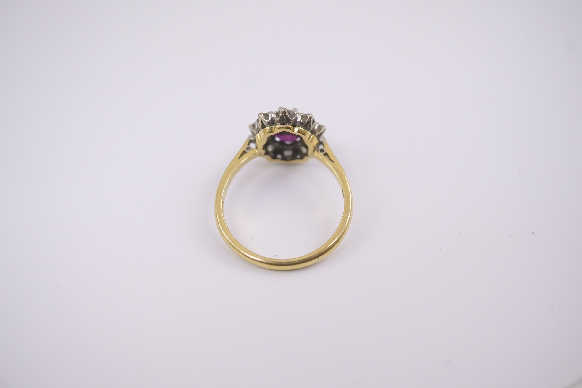 An 18ct gold and platinum, ruby and diamond set oval cluster ring